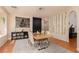 The dining room features a large table, modern art, and hardwood floors at 2691 Rimpacific Cir, Las Vegas, NV 89146