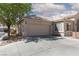 A side view of a charming home, showcasing a spacious driveway and a two-car garage at 2691 Rimpacific Cir, Las Vegas, NV 89146