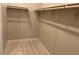 Walk-in closet featuring neutral carpeting, shelving, and clothes rods at 3232 Walker River St, North Las Vegas, NV 89032