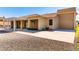 Backyard featuring a covered patio, desert landscaping, and attached garage at 3665 Cottage Stone Ct, Laughlin, NV 89029