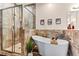 Spa-like bathroom featuring a standalone tub, and a glass-enclosed shower at 3665 Cottage Stone Ct, Laughlin, NV 89029