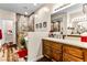 Bathroom showcasing a tiled shower, modern vanity, and decorative accents at 3665 Cottage Stone Ct, Laughlin, NV 89029
