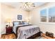 Bedroom featuring wood floors, plantation shutters, ceiling fan, and blue accents at 3665 Cottage Stone Ct, Laughlin, NV 89029