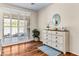 Brightly lit primary bedroom with hardwood flooring and a whitewashed dresser at 3665 Cottage Stone Ct, Laughlin, NV 89029