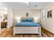 Primary bedroom with hardwood flooring, a whitewashed bed frame, and ensuite bath at 3665 Cottage Stone Ct, Laughlin, NV 89029