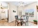 Bright dining area with tile flooring, ceiling fan, and a glass table with seating for four at 3665 Cottage Stone Ct, Laughlin, NV 89029