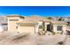 Attractive house showcasing a three-car garage, desert landscaping and mountain views at 3665 Cottage Stone Ct, Laughlin, NV 89029