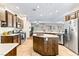 Spacious kitchen with stainless steel appliances, central island, and tile flooring at 3665 Cottage Stone Ct, Laughlin, NV 89029