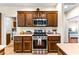 Modern kitchen with stainless steel appliances, custom cabinetry, and tile flooring at 3665 Cottage Stone Ct, Laughlin, NV 89029