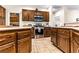 Open kitchen with stainless steel oven and range, and dark wood cabinets at 3665 Cottage Stone Ct, Laughlin, NV 89029