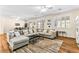 Bright and airy living room with hardwood floors, plantation shutters, and plenty of seating at 3665 Cottage Stone Ct, Laughlin, NV 89029
