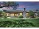 Large backyard with a covered patio, mature landscaping, well-maintained lawn, and desert accents at 4722 Blue Mesa Way, Las Vegas, NV 89129