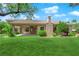 Expansive backyard showcases a well-maintained lawn, mature trees, and the rear of the home at 4722 Blue Mesa Way, Las Vegas, NV 89129