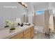 Bathroom features a sink with vanity, a shower-tub combo, and bright natural lighting at 4722 Blue Mesa Way, Las Vegas, NV 89129
