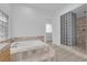 Bathroom with a soaking tub, glass block window, and walk-in shower at 4722 Blue Mesa Way, Las Vegas, NV 89129