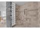 Walk-in shower with a seat and detailed tile work, complete with glass block details at 4722 Blue Mesa Way, Las Vegas, NV 89129