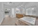 Large bathroom with a tub, vanity, mirrors and view of the backyard at 4722 Blue Mesa Way, Las Vegas, NV 89129
