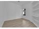 Empty bedroom space with light wood floors and built in shelving at 4722 Blue Mesa Way, Las Vegas, NV 89129