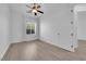 Bedroom with a ceiling fan, neutral walls and wood-look flooring at 4722 Blue Mesa Way, Las Vegas, NV 89129