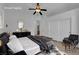 A staged primary bedroom includes a ceiling fan, accent mirror, and neutral color palette at 4722 Blue Mesa Way, Las Vegas, NV 89129