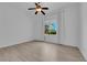 Bright bedroom with neutral walls, wood floors, ceiling fan, and natural light from a window at 4722 Blue Mesa Way, Las Vegas, NV 89129
