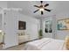 Cozy bedroom with a ceiling fan, closet, and window overlooking lush greenery at 4722 Blue Mesa Way, Las Vegas, NV 89129