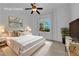 Beautifully staged bedroom with a modern ceiling fan, decorative pillows, and plenty of natural light at 4722 Blue Mesa Way, Las Vegas, NV 89129