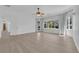 Spacious bedroom with ceiling fan, light-colored floors, and a large window with backyard views at 4722 Blue Mesa Way, Las Vegas, NV 89129