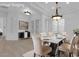 Elegantly staged dining room boasts a marble table, tufted chairs, and modern lighting at 4722 Blue Mesa Way, Las Vegas, NV 89129