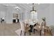 Elegantly staged dining room featuring a marble table, comfortable chairs, and modern light fixtures at 4722 Blue Mesa Way, Las Vegas, NV 89129