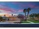 Charming single-story home with a three-car garage, mature landscaping, and a well-maintained lawn at twilight at 4722 Blue Mesa Way, Las Vegas, NV 89129
