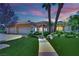 Charming single-story home with a well-manicured lawn, palm trees, and a welcoming walkway to the front entrance at 4722 Blue Mesa Way, Las Vegas, NV 89129