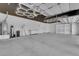 Oversized three-car garage is equipped with shelving, sink, and bright overhead lighting at 4722 Blue Mesa Way, Las Vegas, NV 89129