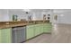 Open concept kitchen featuring countertops, light green cabinets, and stainless appliances at 4722 Blue Mesa Way, Las Vegas, NV 89129