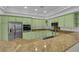 Bright kitchen featuring countertops, light green cabinets, and stainless appliances at 4722 Blue Mesa Way, Las Vegas, NV 89129