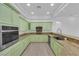 Bright kitchen featuring countertops, light green cabinets, and modern appliances at 4722 Blue Mesa Way, Las Vegas, NV 89129