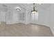 Bright and airy living room with light wood flooring and modern lighting fixtures at 4722 Blue Mesa Way, Las Vegas, NV 89129