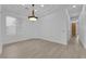 Bright, open living room with wood floors, neutral walls, and stylish light fixture at 4722 Blue Mesa Way, Las Vegas, NV 89129