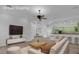 Virtual staging of an open concept home with kitchen, living room and bar stool seating at 4722 Blue Mesa Way, Las Vegas, NV 89129