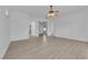 Bright living room with wood-look floors and an open floor plan to a connected hallway at 4722 Blue Mesa Way, Las Vegas, NV 89129