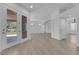Bright living room with wood-style floors and french doors to the backyard at 4722 Blue Mesa Way, Las Vegas, NV 89129