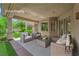 Inviting covered patio features stylish wicker furniture, creating a relaxing outdoor living space at 4722 Blue Mesa Way, Las Vegas, NV 89129