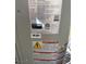 Close-up view of the air conditioner specifications, including model and safety warnings at 6080 Golden Corral Trl # 103, Henderson, NV 89011