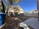 Unfenced backyard featuring block wall and concrete patio, with a view of neighboring homes at 6080 Golden Corral Trl # 103, Henderson, NV 89011