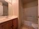 Clean bathroom with tub and wood vanity at 6080 Golden Corral Trl # 103, Henderson, NV 89011