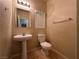 Cozy bathroom featuring a pedestal sink and tile flooring at 6080 Golden Corral Trl # 103, Henderson, NV 89011