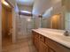 Well-lit bathroom featuring a large vanity and a shower-tub combination at 6080 Golden Corral Trl # 103, Henderson, NV 89011