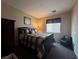 Comfortable bedroom with a plaid comforter, accent chair, and neutral decor at 6080 Golden Corral Trl # 103, Henderson, NV 89011