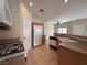 Cozy kitchen featuring tiled floors, modern appliances, and a view of the living space at 6080 Golden Corral Trl # 103, Henderson, NV 89011