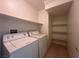 Convenient laundry area with washer, dryer, and shelving for storage at 6080 Golden Corral Trl # 103, Henderson, NV 89011